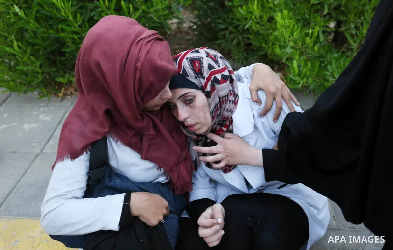 Colleagues of Palestinian medic Abdullah Al-Kotati, who was killed by Israeli troops while trying to help wounded protesters during clashes where Palestinians demand the right to return to their homeland at the Israel-Ga...