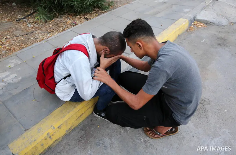 Colleagues of Palestinian medic Abdullah Al-Kotati, who was killed by Israeli troops while trying to help wounded protesters during clashes where Palestinians demand the right to return to their homeland at the Israel-Ga...