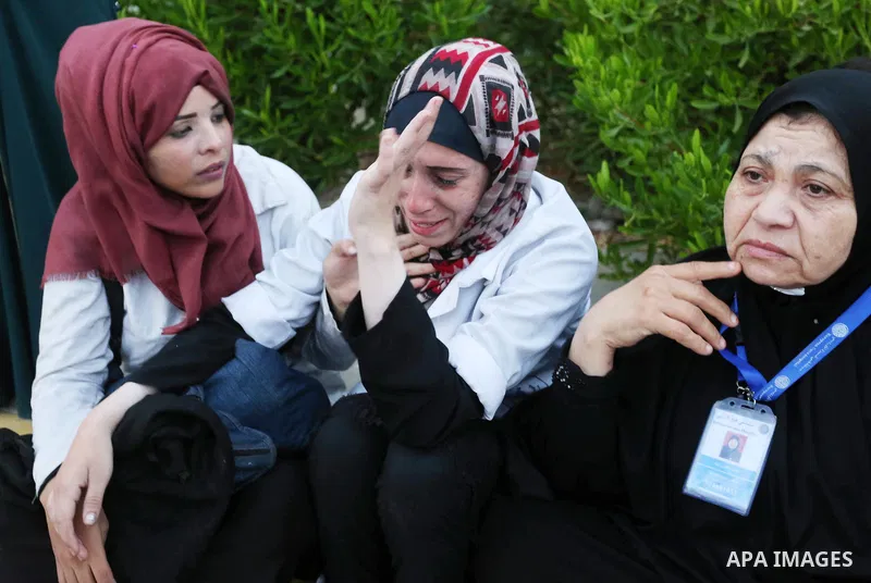 Colleagues of Palestinian medic Abdullah Al-Kotati, who was killed by Israeli troops while trying to help wounded protesters during clashes where Palestinians demand the right to return to their homeland at the Israel-Ga...