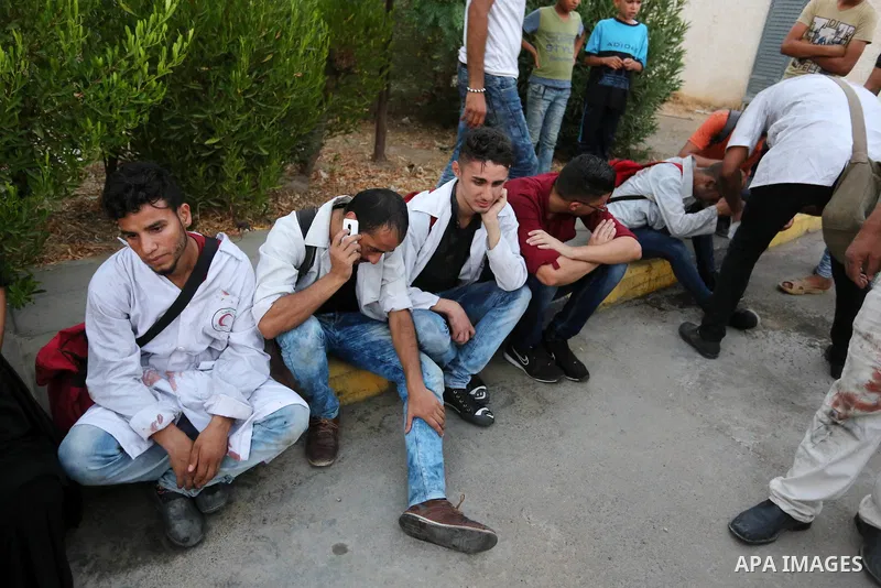 Colleagues of Palestinian medic Abdullah Al-Kotati, who was killed by Israeli troops while trying to help wounded protesters during clashes where Palestinians demand the right to return to their homeland at the Israel-Ga...