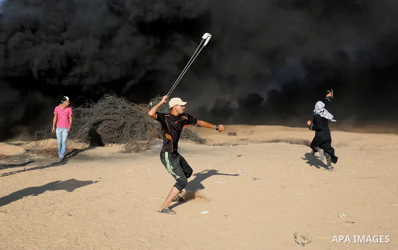 Palestinian protesters gather during clashes with Israeli troops in tents protest where Palestinians demand the right to return to their homeland at the Israel-Gaza border, in Khan Younis in the southern Gaza Strip on Au...