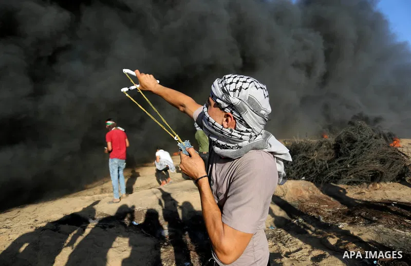 Palestinian protesters gather during clashes with Israeli troops in tents protest where Palestinians demand the right to return to their homeland at the Israel-Gaza border, in Khan Younis in the southern Gaza Strip on Au...