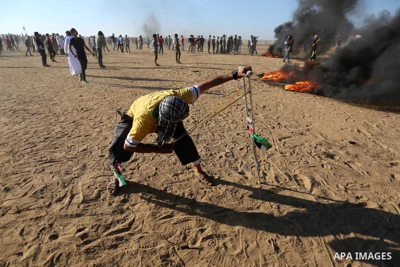Palestinian protesters gather during clashes with Israeli troops in tents protest where Palestinians demand the right to return to their homeland at the Israel-Gaza border, in Khan Younis in the southern Gaza Strip on Au...