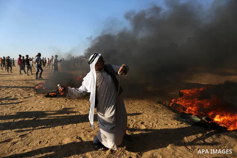 Palestinian protesters gather during clashes with Israeli troops in tents protest where Palestinians demand the right to return to their homeland at the Israel-Gaza border, in Khan Younis in the southern Gaza Strip on Au...
