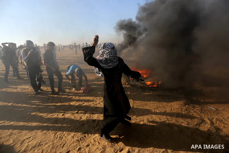 Palestinian protesters gather during clashes with Israeli troops in tents protest where Palestinians demand the right to return to their homeland at the Israel-Gaza border, in Khan Younis in the southern Gaza Strip on Au...