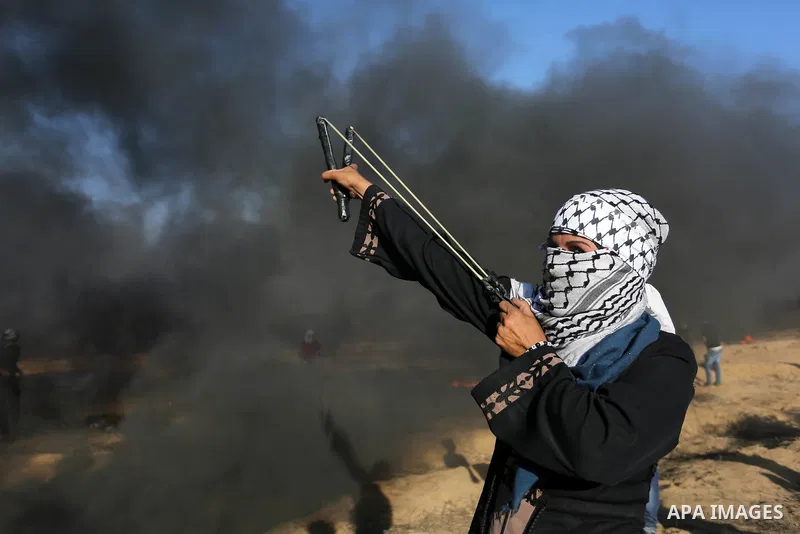 Palestinian protesters gather during clashes with Israeli troops in tents protest where Palestinians demand the right to return to their homeland at the Israel-Gaza border, in Khan Younis in the southern Gaza Strip on Au...