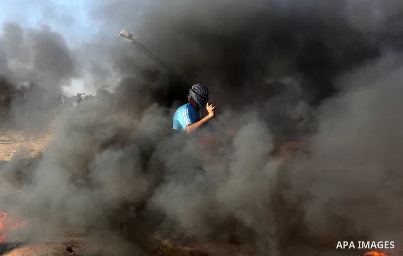 Palestinian protesters gather during clashes with Israeli troops in tents protest where Palestinians demand the right to return to their homeland at the Israel-Gaza border, in Khan Younis in the southern Gaza Strip on Au...