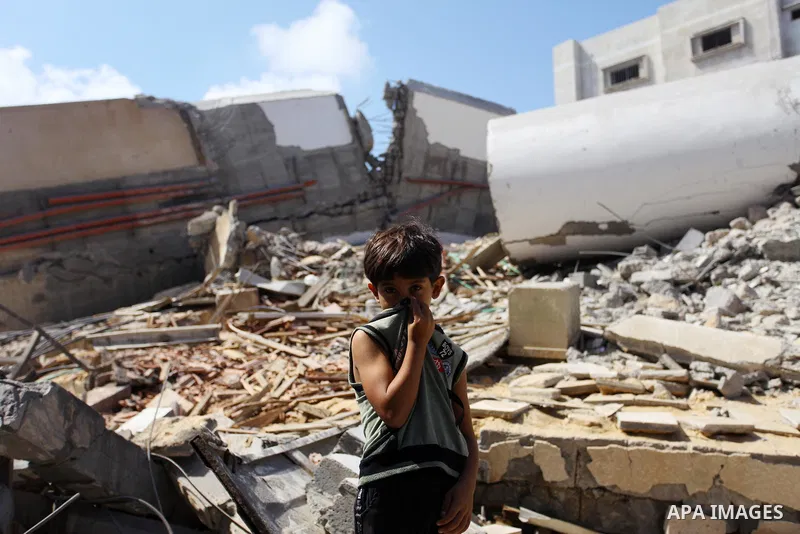 A Palestinian boy stands on the rubble of Said al-Mishal Cultural Center which was destroyed by an Israeli air strike in Gaza city on Aug. 11, 2018. Photo by Mahmoud Ajour