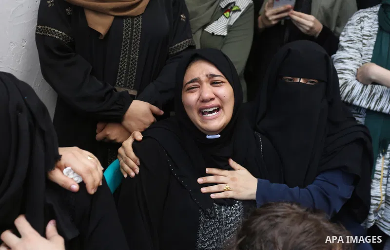 Relatives of Palestinian volunteer medic Abdullah Al-Kotati, who was killed the day before by Israeli troops while trying to help wounded protesters during clashes where Palestinians demand the right to return to their h...