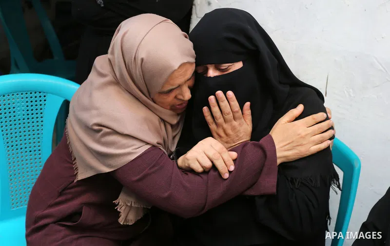 Relatives of Palestinian volunteer medic Abdullah Al-Kotati, who was killed the day before by Israeli troops while trying to help wounded protesters during clashes where Palestinians demand the right to return to their h...