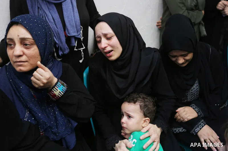 Relatives of Palestinian volunteer medic Abdullah Al-Kotati, who was killed the day before by Israeli troops while trying to help wounded protesters during clashes where Palestinians demand the right to return to their h...