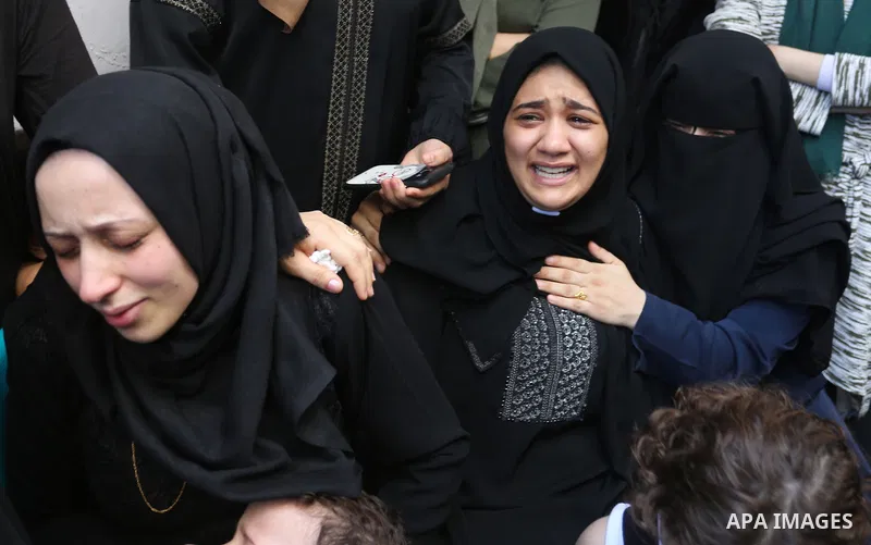 Relatives of Palestinian volunteer medic Abdullah Al-Kotati, who was killed the day before by Israeli troops while trying to help wounded protesters during clashes where Palestinians demand the right to return to their h...