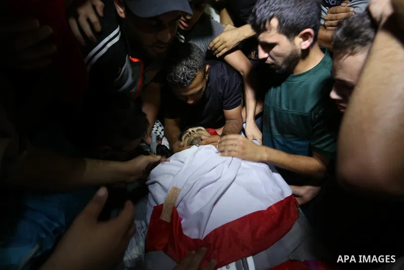Relatives of Palestinian volunteer medic Abdullah Al-Kotati, who was killed the day before by Israeli troops while trying to help wounded protesters during clashes where Palestinians demand the right to return to their h...