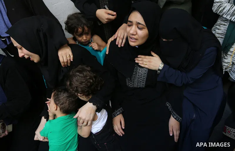 Relatives of Palestinian volunteer medic Abdullah Al-Kotati, who was killed the day before by Israeli troops while trying to help wounded protesters during clashes where Palestinians demand the right to return to their h...