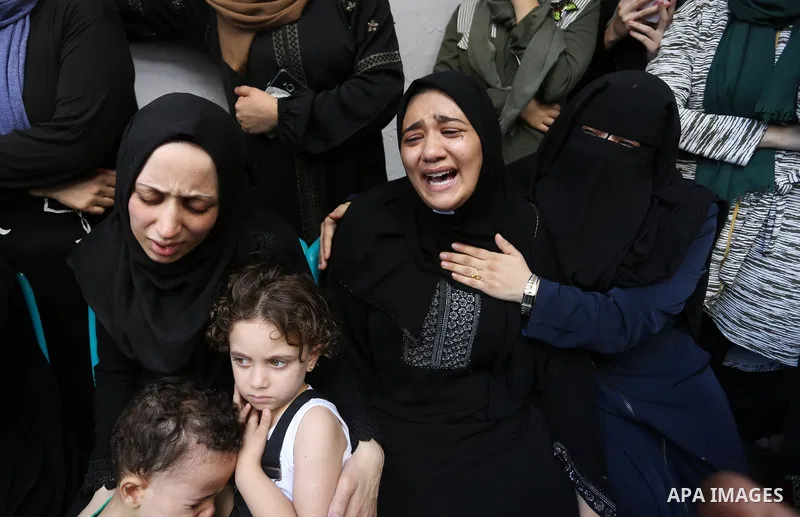 Relatives of Palestinian volunteer medic Abdullah Al-Kotati, who was killed the day before by Israeli troops while trying to help wounded protesters during clashes where Palestinians demand the right to return to their h...