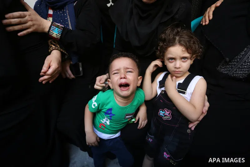 Relatives of Palestinian volunteer medic Abdullah Al-Kotati, who was killed the day before by Israeli troops while trying to help wounded protesters during clashes where Palestinians demand the right to return to their h...