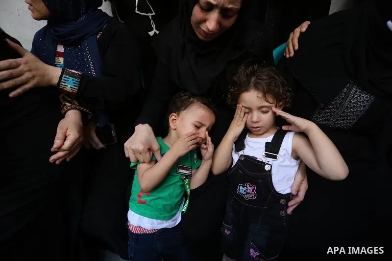 Relatives of Palestinian volunteer medic Abdullah Al-Kotati, who was killed the day before by Israeli troops while trying to help wounded protesters during clashes where Palestinians demand the right to return to their h...