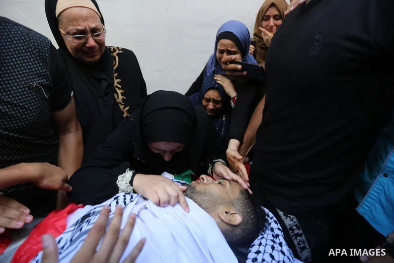 Relatives of Palestinian volunteer medic Abdullah Al-Kotati, who was killed the day before by Israeli troops while trying to help wounded protesters during clashes where Palestinians demand the right to return to their h...