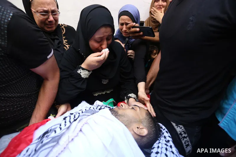 Relatives of Palestinian volunteer medic Abdullah Al-Kotati, who was killed the day before by Israeli troops while trying to help wounded protesters during clashes where Palestinians demand the right to return to their h...