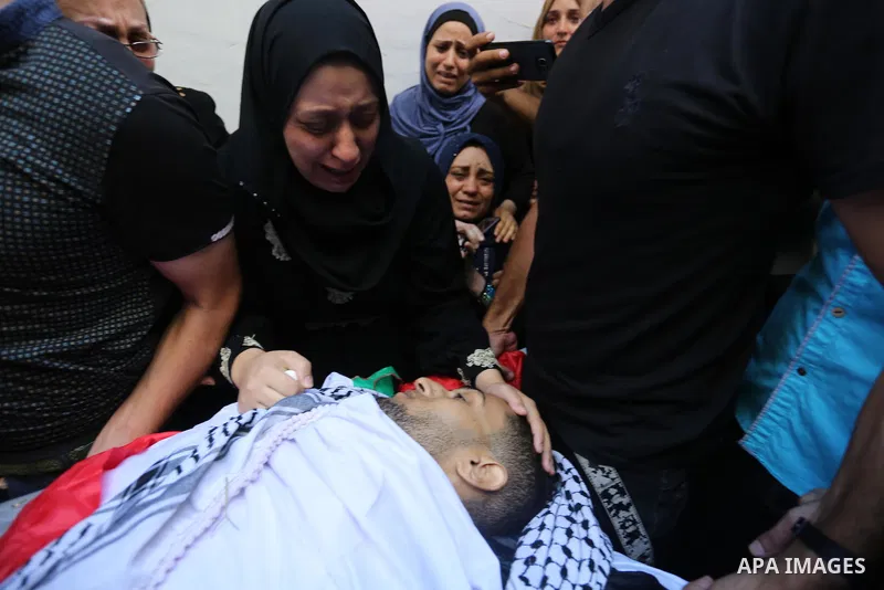 Relatives of Palestinian volunteer medic Abdullah Al-Kotati, who was killed the day before by Israeli troops while trying to help wounded protesters during clashes where Palestinians demand the right to return to their h...