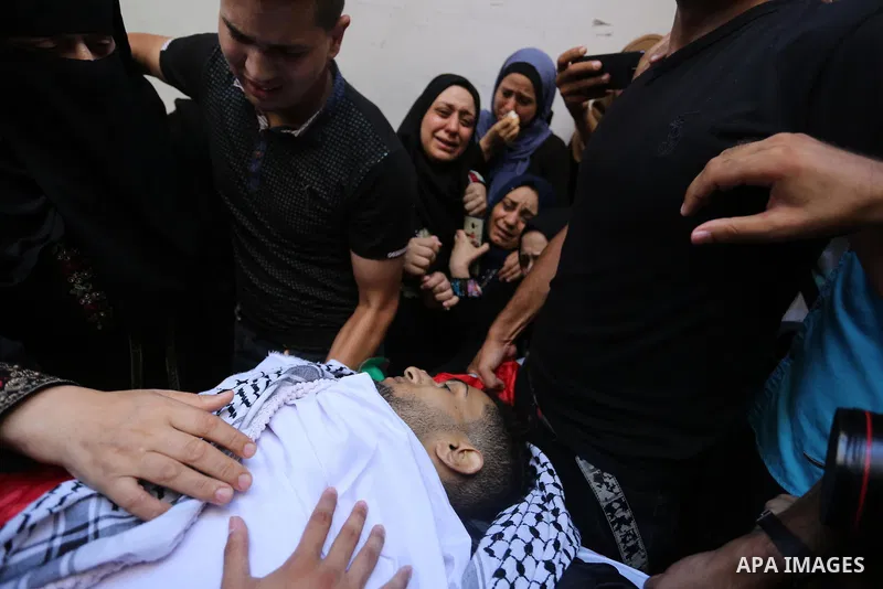 Relatives of Palestinian volunteer medic Abdullah Al-Kotati, who was killed the day before by Israeli troops while trying to help wounded protesters during clashes where Palestinians demand the right to return to their h...