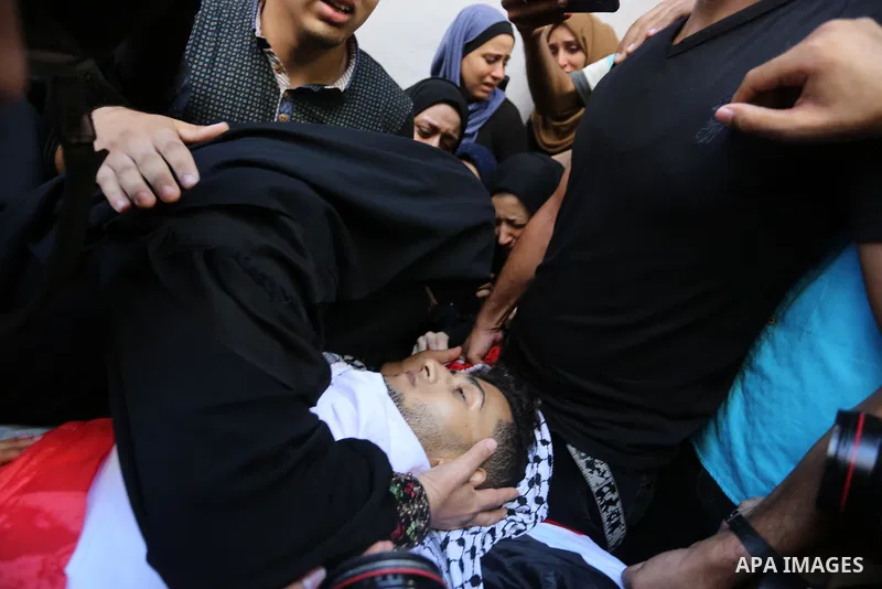 Relatives of Palestinian volunteer medic Abdullah Al-Kotati, who was killed the day before by Israeli troops while trying to help wounded protesters during clashes where Palestinians demand the right to return to their h...