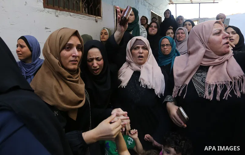 Relatives of Palestinian volunteer medic Abdullah Al-Kotati, who was killed the day before by Israeli troops while trying to help wounded protesters during clashes where Palestinians demand the right to return to their h...
