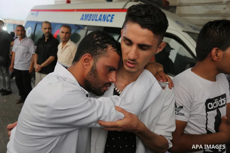 Colleagues of Palestinian volunteer medic Abdullah Al-Kotati, who was killed the day before by Israeli troops while trying to help wounded protesters during clashes where Palestinians demand the right to return to their...
