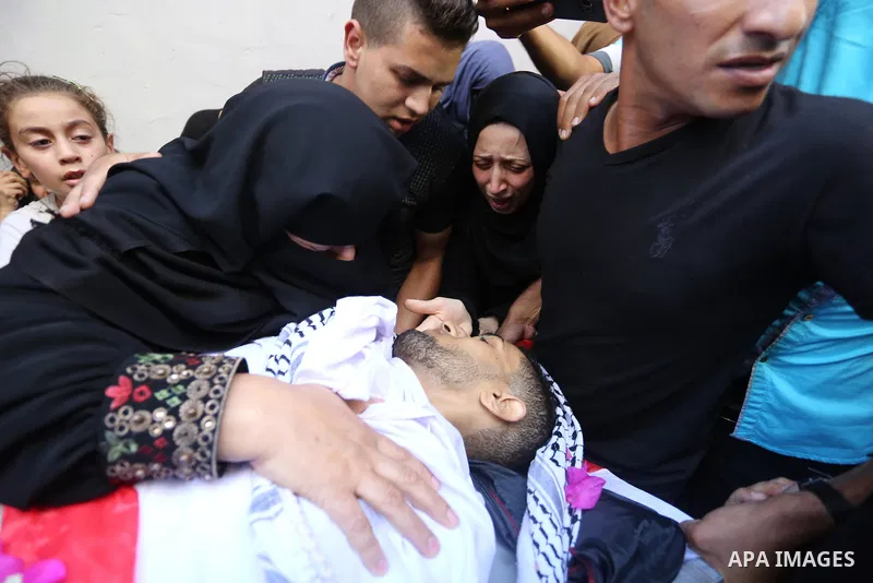Relatives of Palestinian volunteer medic Abdullah Al-Kotati, who was killed the day before by Israeli troops while trying to help wounded protesters during clashes where Palestinians demand the right to return to their h...