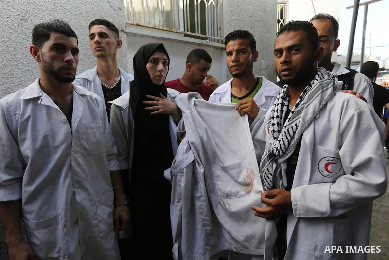 Colleagues of Palestinian volunteer medic Abdullah Al-Kotati, who was killed the day before by Israeli troops while trying to help wounded protesters during clashes where Palestinians demand the right to return to their...