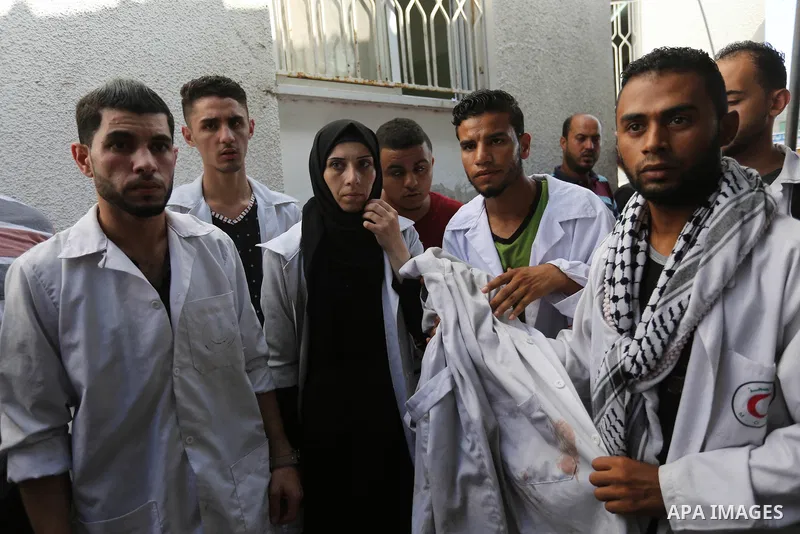 Colleagues of Palestinian volunteer medic Abdullah Al-Kotati, who was killed the day before by Israeli troops while trying to help wounded protesters during clashes where Palestinians demand the right to return to their...
