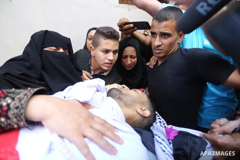 Relatives of Palestinian volunteer medic Abdullah Al-Kotati, who was killed the day before by Israeli troops while trying to help wounded protesters during clashes where Palestinians demand the right to return to their h...