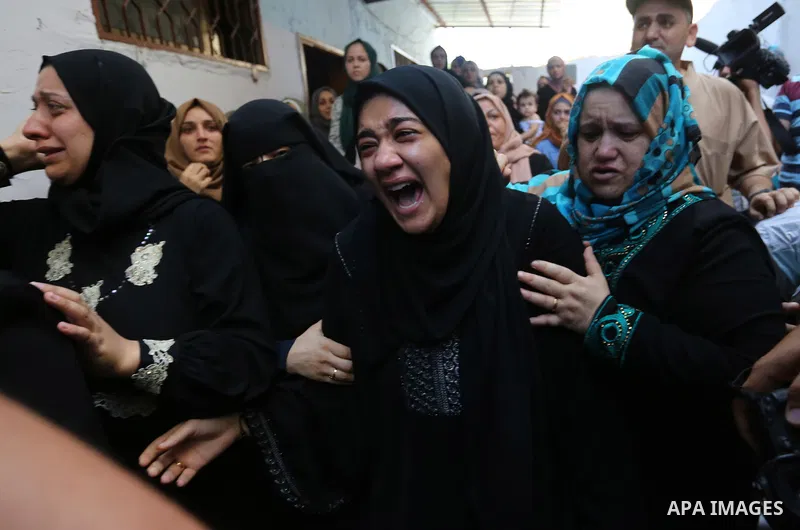 Relatives of Palestinian volunteer medic Abdullah Al-Kotati, who was killed the day before by Israeli troops while trying to help wounded protesters during clashes where Palestinians demand the right to return to their h...