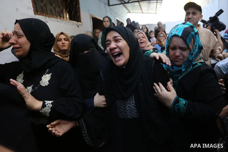 Relatives of Palestinian volunteer medic Abdullah Al-Kotati, who was killed the day before by Israeli troops while trying to help wounded protesters during clashes where Palestinians demand the right to return to their h...