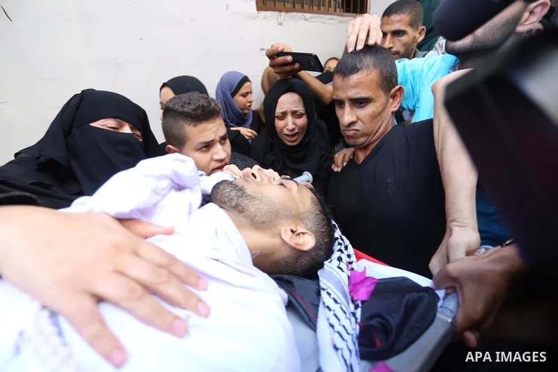Relatives of Palestinian volunteer medic Abdullah Al-Kotati, who was killed the day before by Israeli troops while trying to help wounded protesters during clashes where Palestinians demand the right to return to their h...