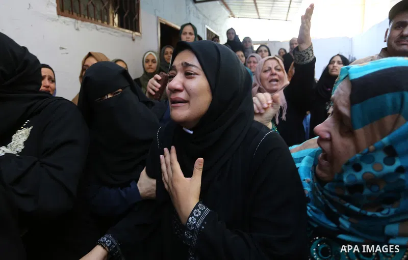 Relatives of Palestinian volunteer medic Abdullah Al-Kotati, who was killed the day before by Israeli troops while trying to help wounded protesters during clashes where Palestinians demand the right to return to their h...
