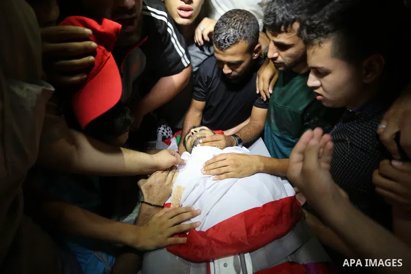 Relatives of Palestinian volunteer medic Abdullah Al-Kotati, who was killed the day before by Israeli troops while trying to help wounded protesters during clashes where Palestinians demand the right to return to their h...