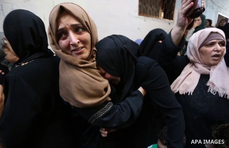 Relatives of Palestinian volunteer medic Abdullah Al-Kotati, who was killed the day before by Israeli troops while trying to help wounded protesters during clashes where Palestinians demand the right to return to their h...