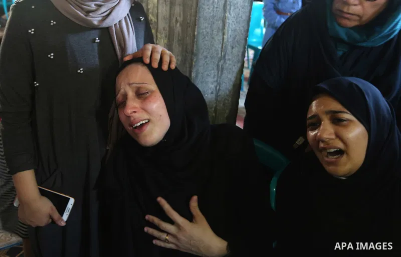 Relatives of Palestinian volunteer medic Abdullah Al-Kotati, who was killed the day before by Israeli troops while trying to help wounded protesters during clashes where Palestinians demand the right to return to their h...