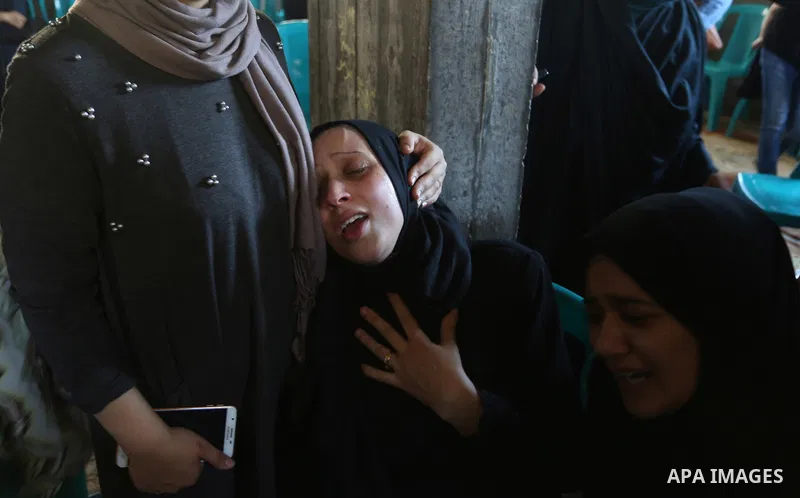 Relatives of Palestinian volunteer medic Abdullah Al-Kotati, who was killed the day before by Israeli troops while trying to help wounded protesters during clashes where Palestinians demand the right to return to their h...