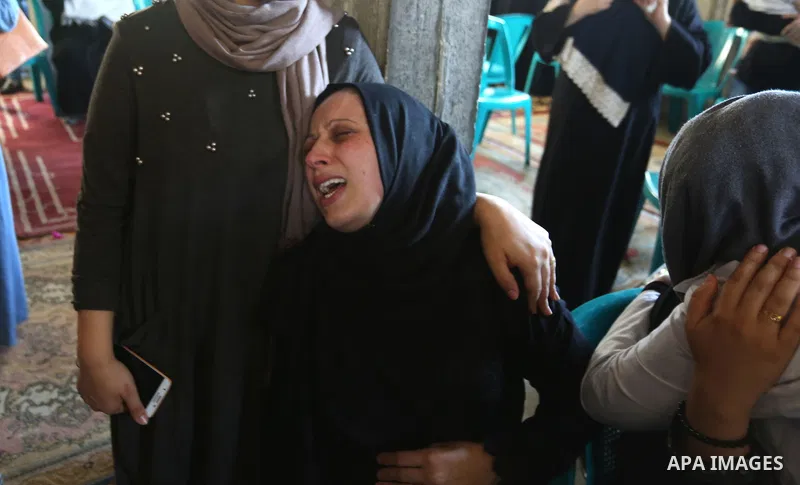 Relatives of Palestinian volunteer medic Abdullah Al-Kotati, who was killed the day before by Israeli troops while trying to help wounded protesters during clashes where Palestinians demand the right to return to their h...