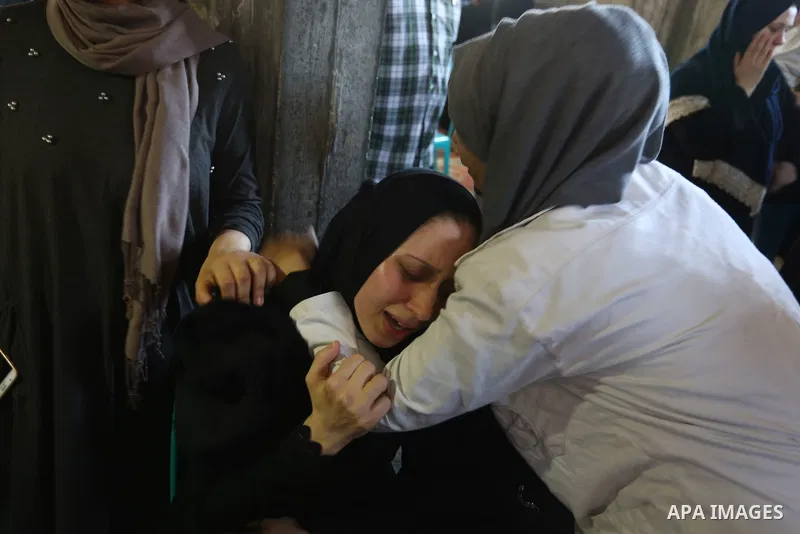 Colleagues and relatives of Palestinian volunteer medic Abdullah Al-Kotati, who was killed the day before by Israeli troops while trying to help wounded protesters during clashes where Palestinians demand the right to re...