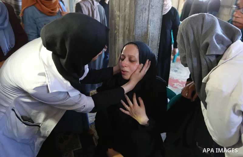 Colleagues and relatives of Palestinian volunteer medic Abdullah Al-Kotati, who was killed the day before by Israeli troops while trying to help wounded protesters during clashes where Palestinians demand the right to re...