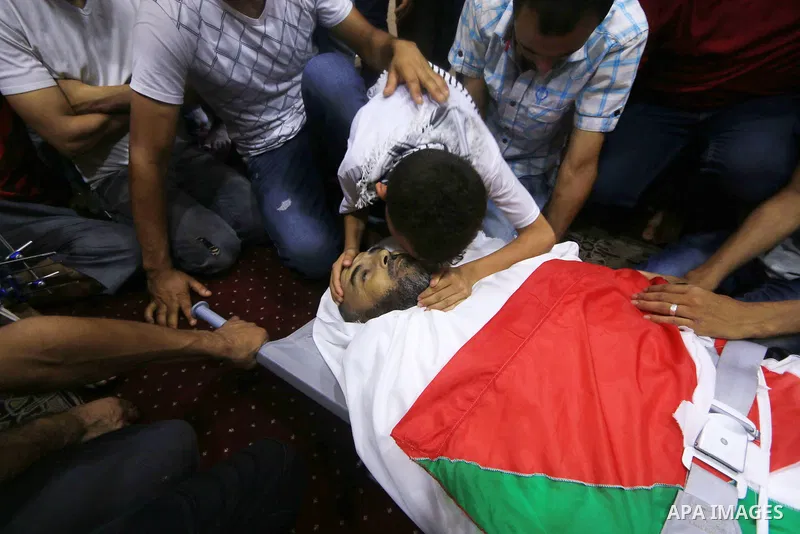 Relatives of Palestinian Ali Aloul, 55, who was killed the day before by Israeli troops during clashes where Palestinians demand the right to return to their homeland at the Israel-Gaza border, mourn over of his body dur...
