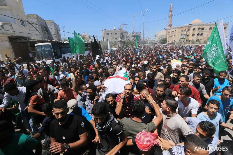 Mourners carry the bodies of Palestinian Ali Aloul, 55, and Ahmed Abu Louly who were killed by Israeli troops during clashes where Palestinians demand the right to return to their homeland at the Israel-Gaza border, duri...