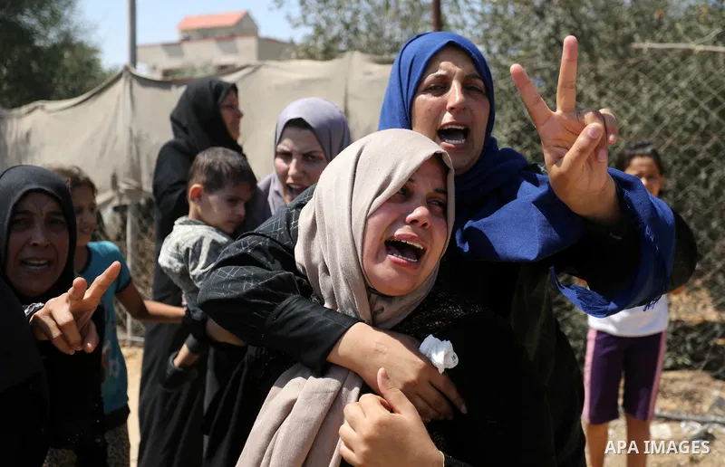 Relatives of Palestinian Ahmed Abu Louly who was killed by Israeli troops during clashes where Palestinians demand the right to return to their homeland at the Israel-Gaza border, mourn during his funeral in Rafah in the...