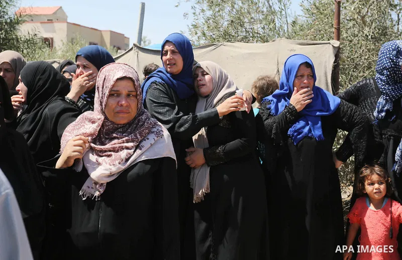 Relatives of Palestinian Ahmed Abu Louly who was killed by Israeli troops during clashes where Palestinians demand the right to return to their homeland at the Israel-Gaza border, mourn during his funeral in Rafah in the...
