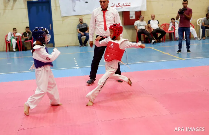 Palestinian children compete during taekwondo championship, in the West Bank city of Ramallah on August 11, 2018. Photo by Shadi Hatem