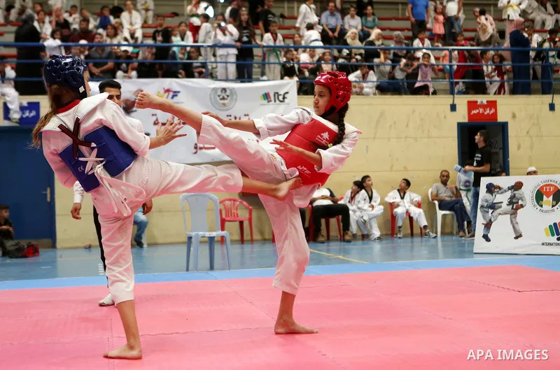 Palestinian children compete during taekwondo championship, in the West Bank city of Ramallah on August 11, 2018. Photo by Shadi Hatem