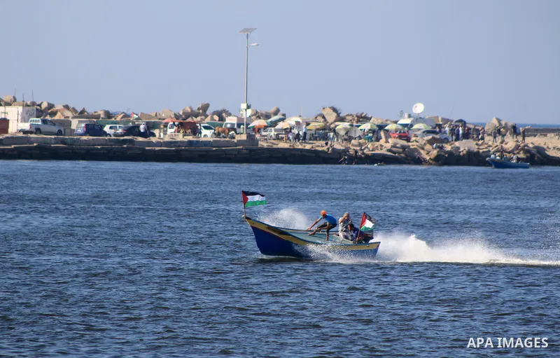 Palestinians ride fishing boats during a rally to break Israel's blockade on Gaza Strip, at the sea in Gaza City, on Aug. 11, 2018. Photo by Mahmoud Khattab